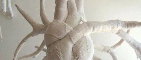 Anatomical art: a soft, white, human body made of old sheets